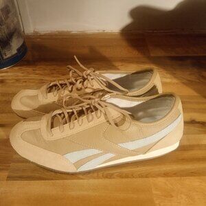 Women's tan Reebok sneakers.